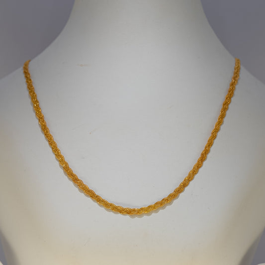 Yellow beaded necklace on a mannequin bust against a gray background