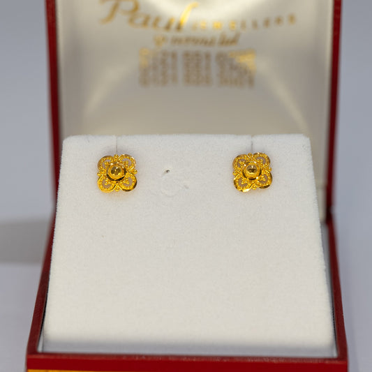 Gold earrings in a red and gold box with 'Paul' branding.