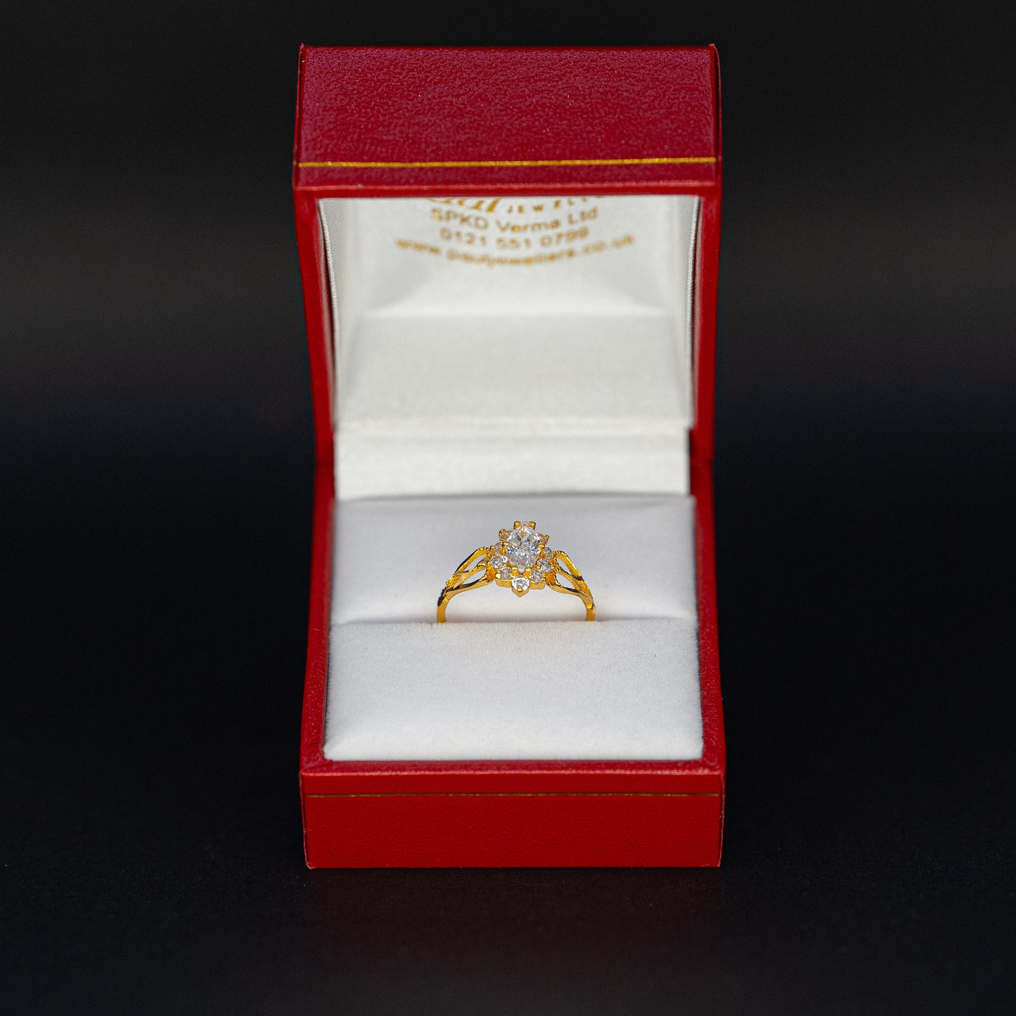 Gold ring in a red box on a black background