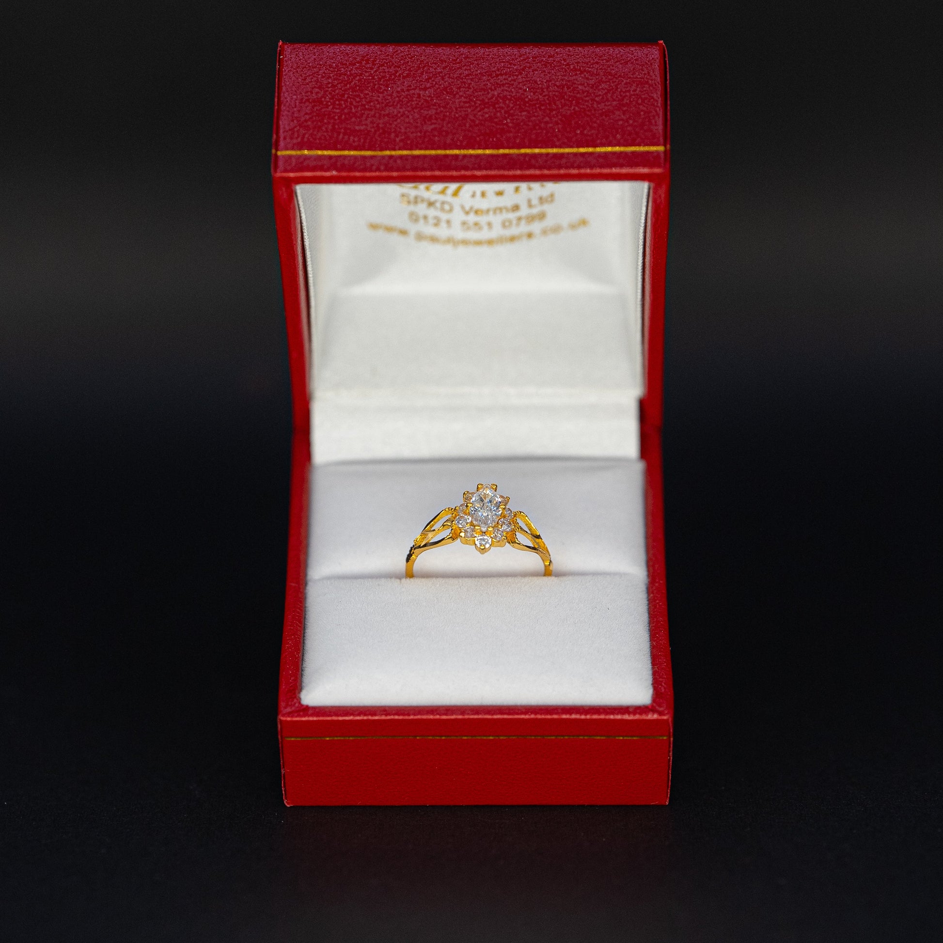 Gold ring in a red box on a black background