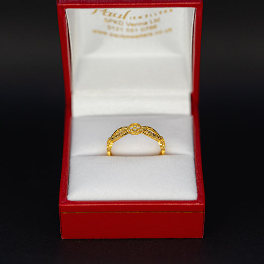 Gold ring in a red box with a white interior