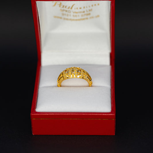 Gold ring in a red box with 'Paul' branding on a black background