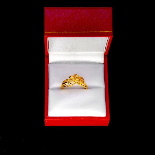 Gold ring in a red jewelry box on a black background