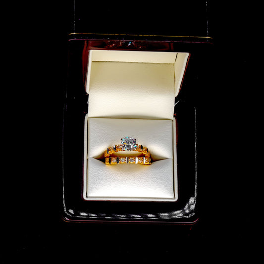Gold ring with a diamond in an open jewelry box on a black background