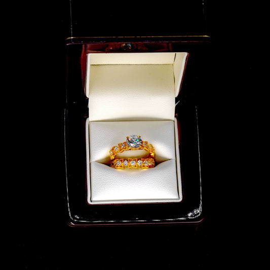 Gold ring with a diamond in an open jewelry box on a black background
