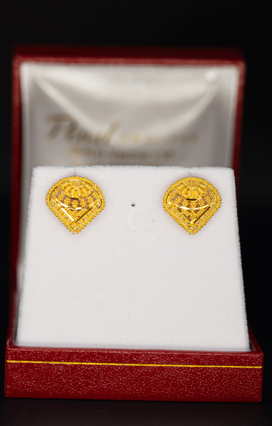 Gold earrings in a red box with a white interior