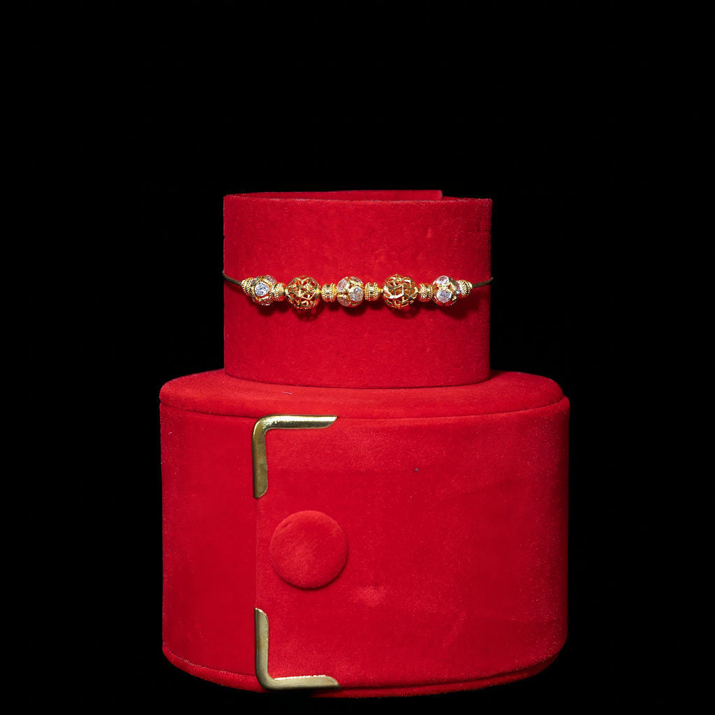 Red jewelry box with gold accents on a black background