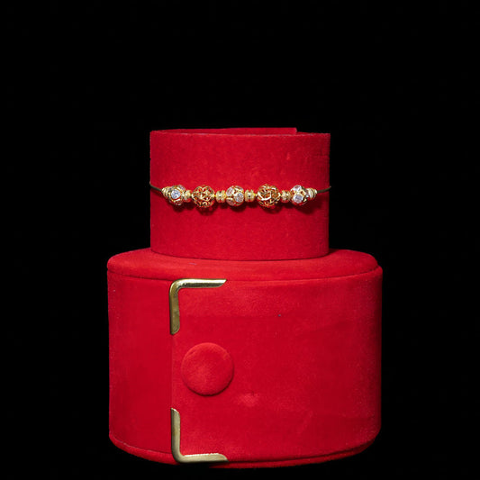 Red jewelry box with gold accents on a black background
