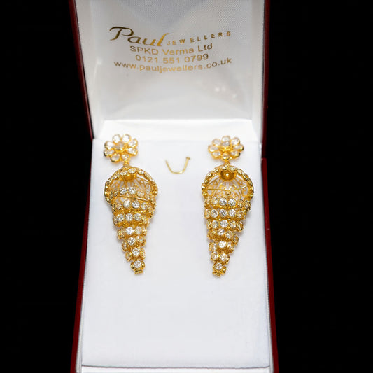 Gold earrings in a box with 'Paul Jewelers' branding on a black background