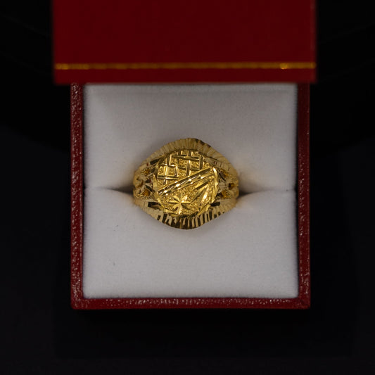A gold signet ring with an embossed crest, presented inside an open red jewelry box with a white velvet cushion against a black background.