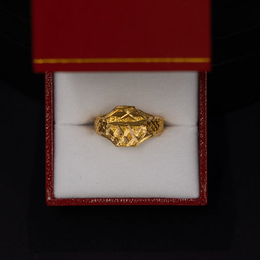 A small gold ring displayed inside an open red jewelry box with a white interior, set against a dark black background.