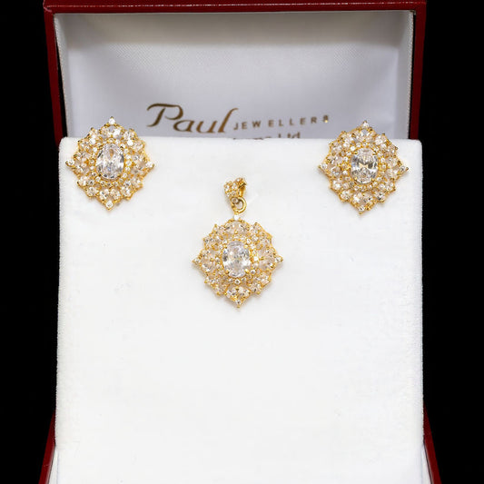 Gold earrings in a Paul Jewellers box on a white background